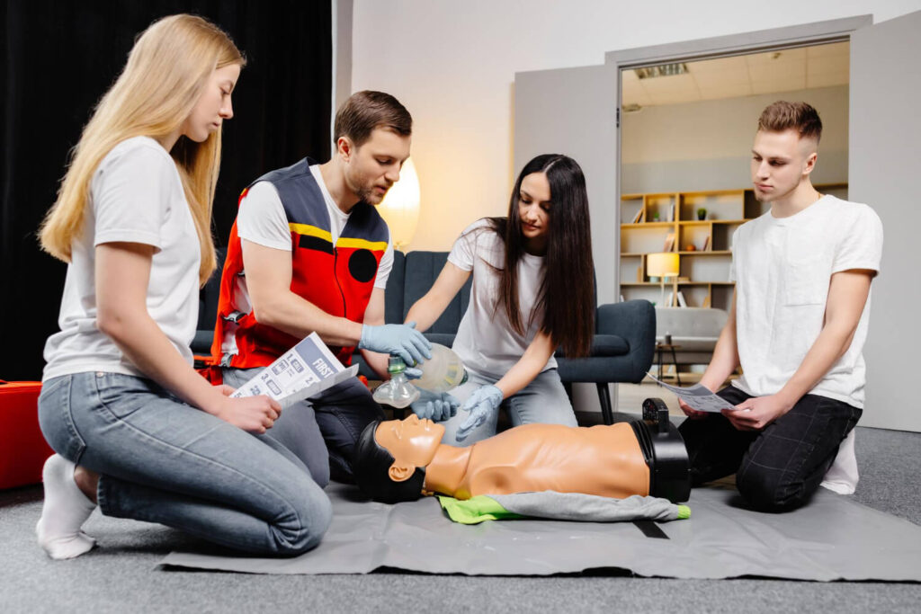 Instructor teaching people how use AED with CPR