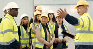 Construction site, teamwork and people in presentation for planning, meeting and discussion in building. Architecture, engineering and men and women for inspection, property development and project.