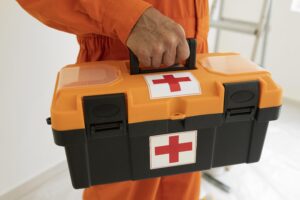 A man holding a regulation 3 first aid kit